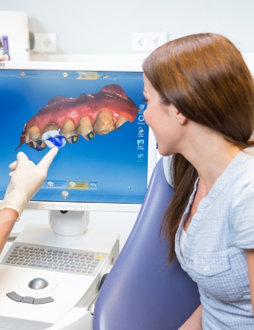 Dental patient looking at digital impressions on chairside computer screen