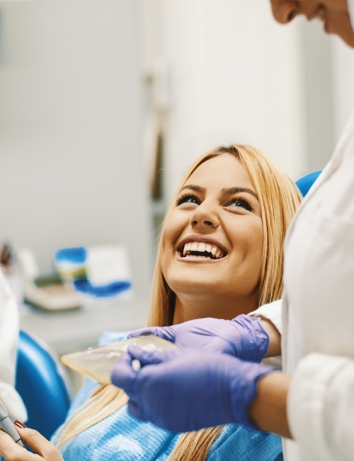 Laughing woman during preventive dentistry checkup and teeth cleaning