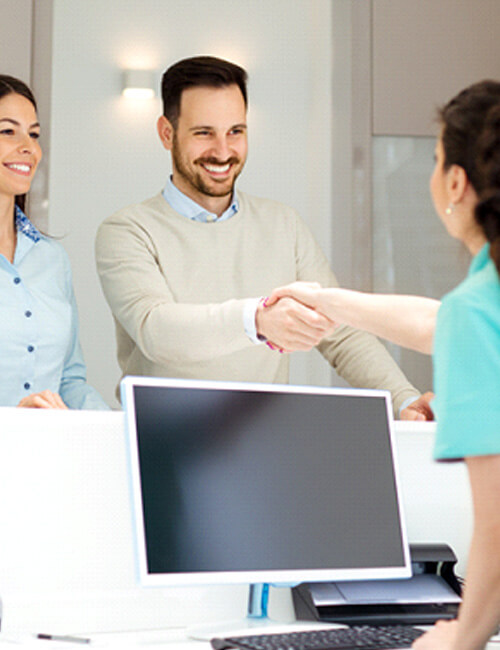 couple talking to receptionist