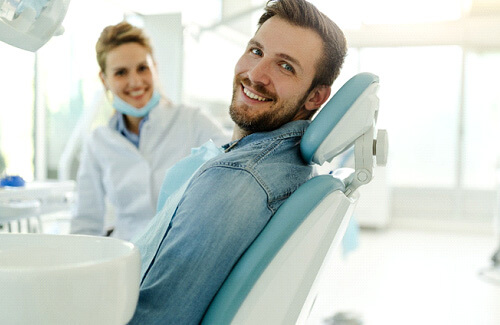 Closeup of patient smiling while reclined in treatment chair