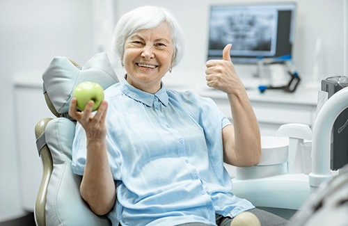 woman smiling about the cost of dental implants in Taylor