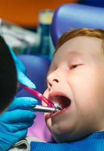 child smiling while visiting dentist 