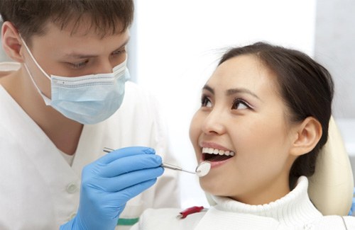 woman visiting dentist for routine checkup   