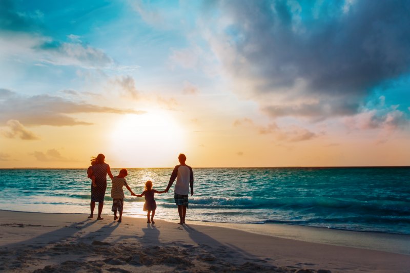 family playing on the beach