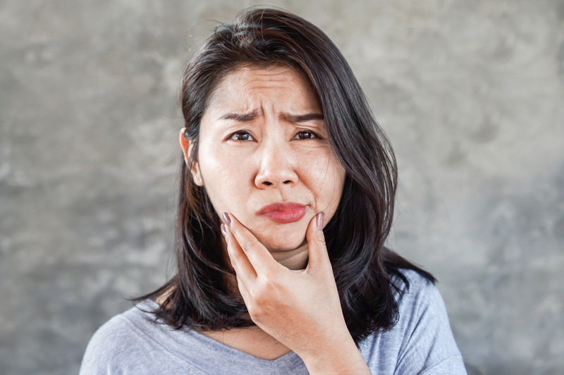 Patient wincing from a dental emergency