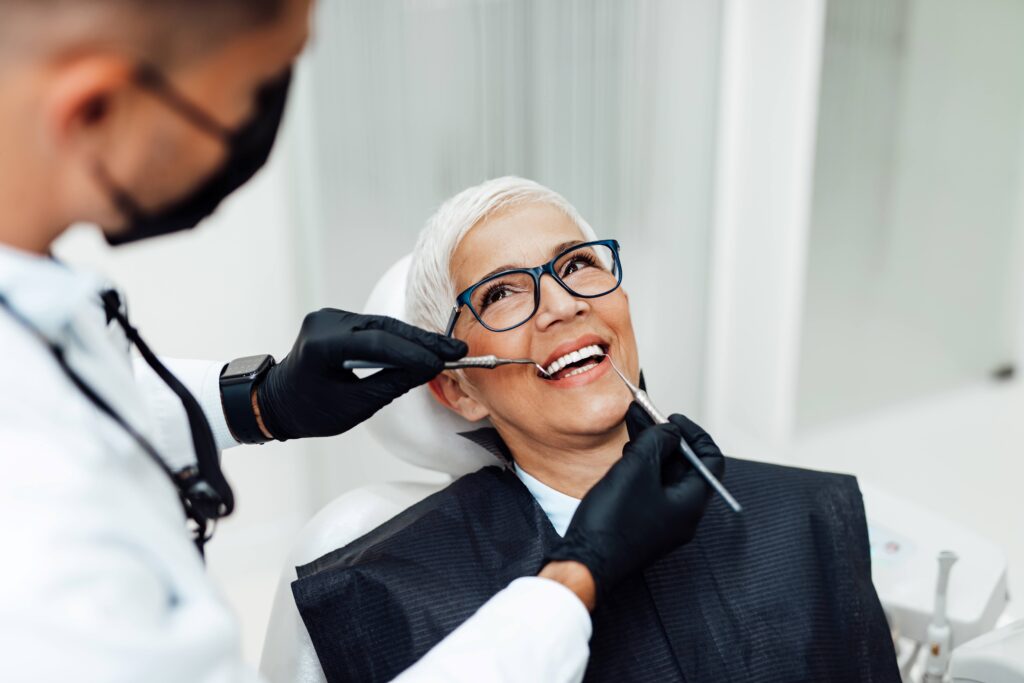 Woman smiling at dentist during checkup